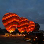 top places to visit in Kenya — Masai Mara game drive at dawn with hot air balloon in background