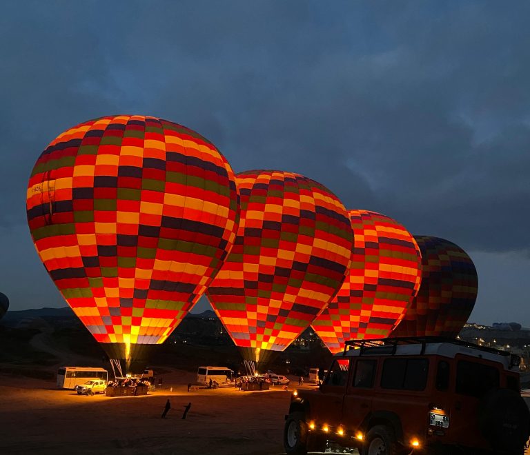 top places to visit in Kenya — Masai Mara game drive at dawn with hot air balloon in background